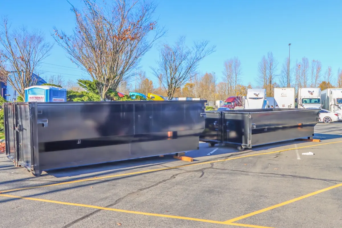 Professional dumpster rental service with roll-off container on residential driveway in Idabel
